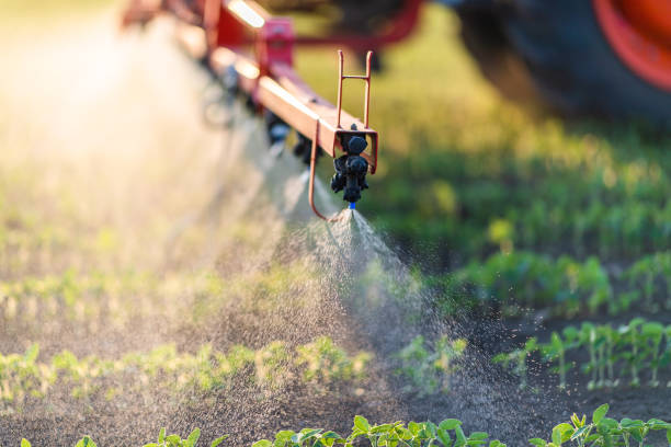 Nozzle of the tractor sprinklers Nozzle of the tractor sprinklers sprayed.Soybean spraying. apply fertilizer stock pictures, royalty-free photos & images