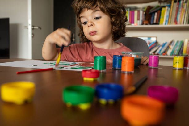 istock Cute little boy doing art work at home 1400596257