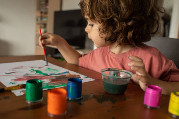 istock Little boy painting at home 1400596265