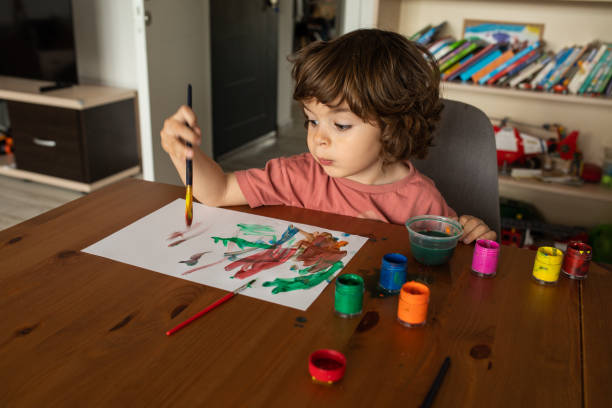 istock Cute little boy doing art work at home 1400596488