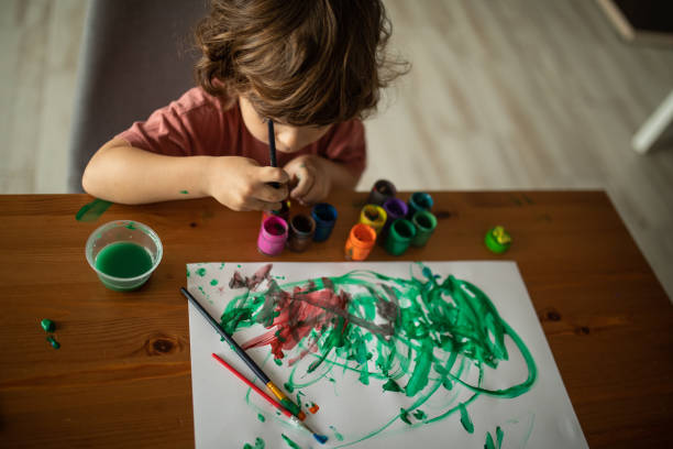 istock Little boy painting at home 1400596489