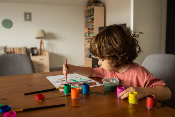 istock Little boy painting at home 1400596600