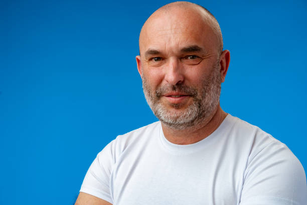 istock Portrait of a middle-aged man against blue background in studio 1400597524