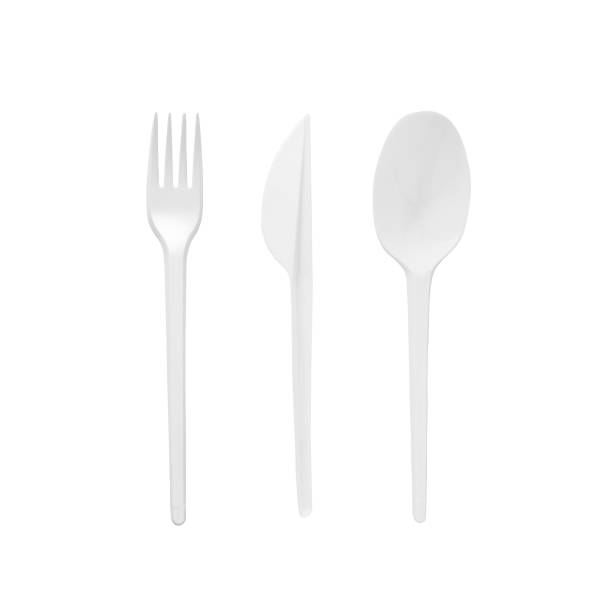 istock White plastic disposable spoon, fork and knife isolated on white background. 1400597615