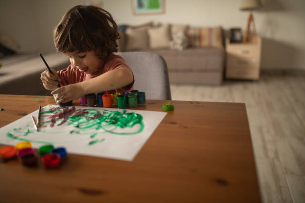 istock Little boy painting at home 1400597802