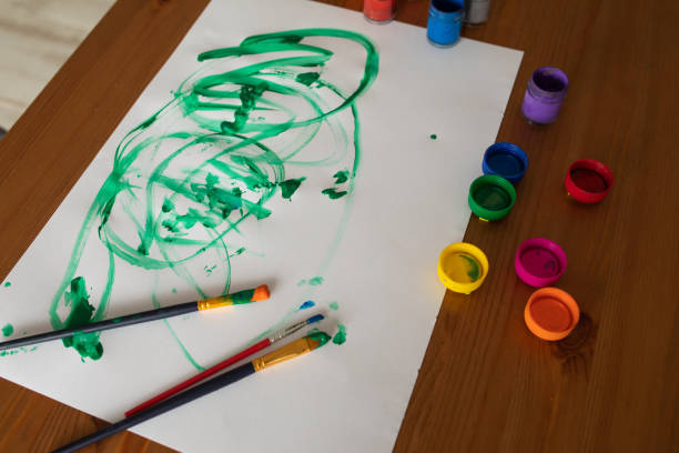 istock Paper paint brush and colorful paints on the table 1400597980