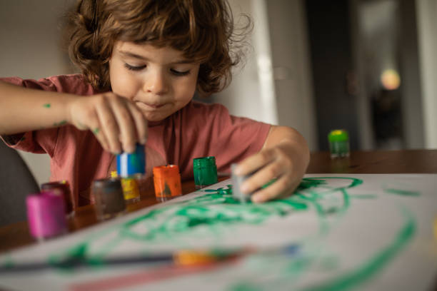 istock Little boy painting at home 1400598248