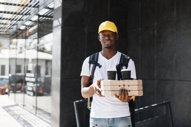 istock Male courier with pizza waiting for the recipient. 1400598429