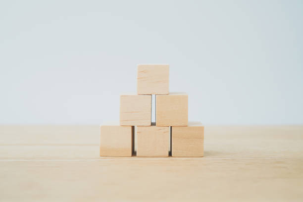 istock pyramid blank wooden block isolated on desk with blue  background for graphic resource element of banner design  concept 1400598587