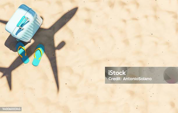 Aircraft Flying Over Sandy Beach With Suitcase And Flip Flops Stock Photo - Download Image Now
