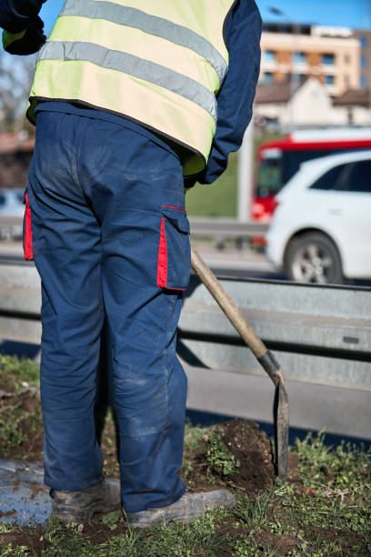 istock Worker with uniform maintaining street lawn. 1400601530