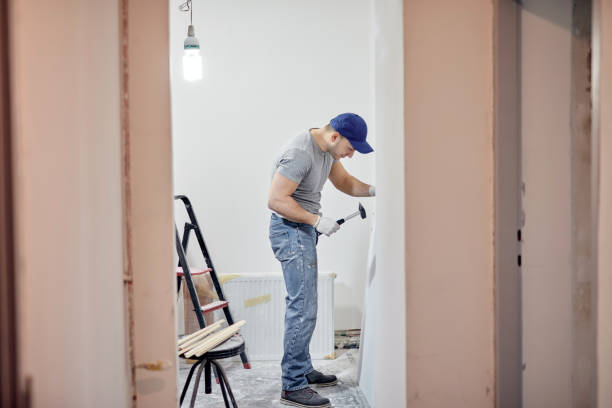 Young adult man painting and fixing on a DIY budget renovation of his new home apartment. Young adult man painting and fixing on a DIY budget renovation of his new home apartment. hobbyist stock pictures, royalty-free photos & images