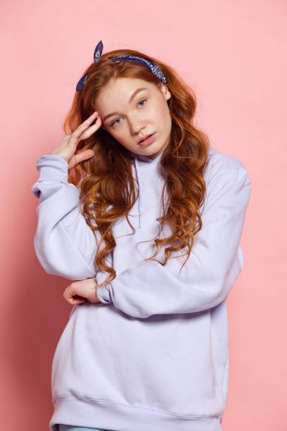 istock Sad young redhead girl, student posing isolated on pink studio background. Human emotions, facial expression concept. Trendy colors 1400601885