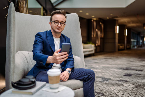 istock Business Man using mobile phone in nature and taking photos 1400603268