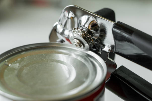 istock Tin opener opening a can in a kitchen. 1400603782