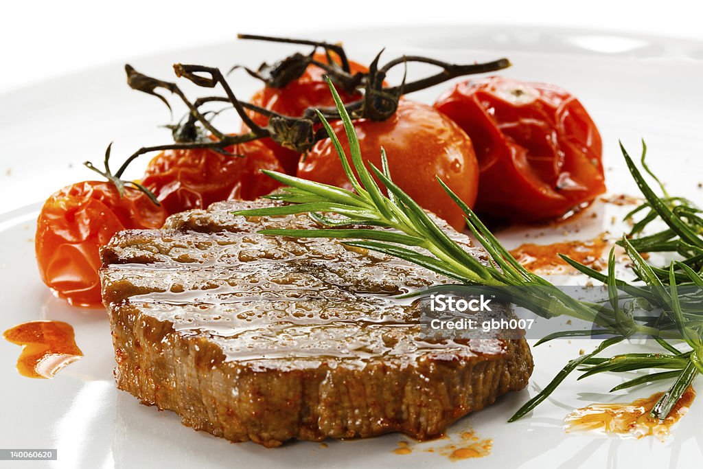 Grilled beefsteak and fried tomatoes Grilled meat and vegetables Beef Stock Photo
