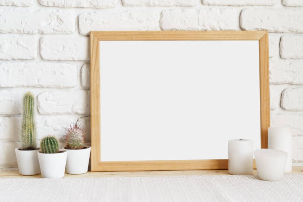 istock Square wooden photo frame and cactus plants on the table 1400606987