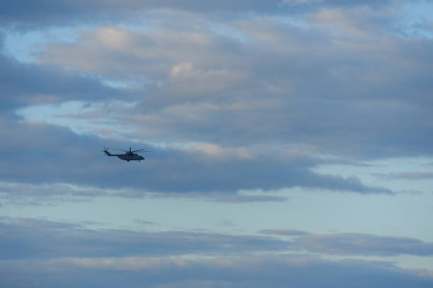 istock Russian military helicopter in the evening sky with clouds 1400608576