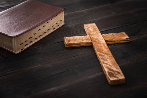 istock wooden cross with Holy Bible 1400610579