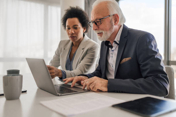 istock Focused professionals planning business strategy on laptop during office meeting 1400610601