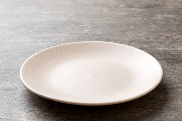 istock Perspective view of empty light plate on cement background. Empty space for your design 1400611617