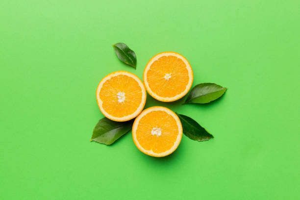 istock Fruit pattern of fresh orange slices on colored background. Top view. Copy Space. creative summer concept. Half of citrus in minimal flat lay 1400611688