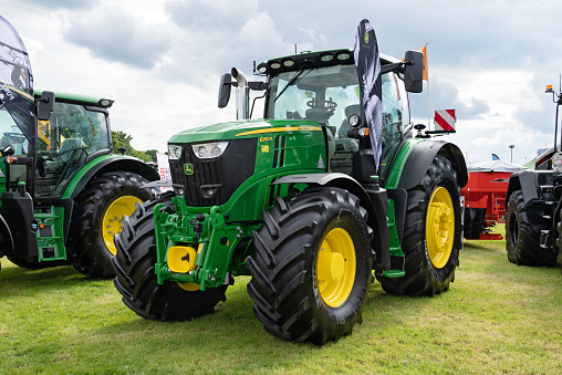 Staffordshire, England - A John Deere 6250R Tractor on display at an agricultural show. The John Deere 6250R has a 250bhp engine.