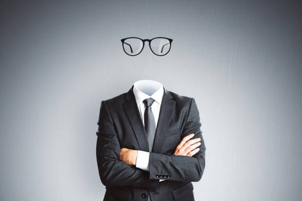 headless invisible businessman in suit with folded arms and abstract glasses standing on gray wall background. business and secret concept. - spy secrecy top secret mystery imagens e fotografias de stock