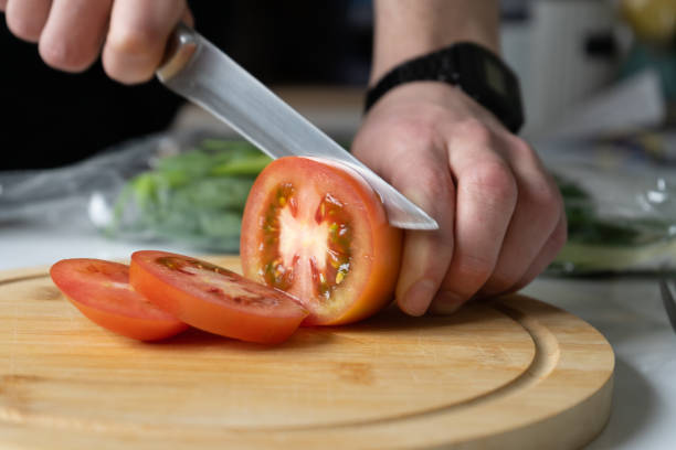 istock person slices a tomato 1400613068