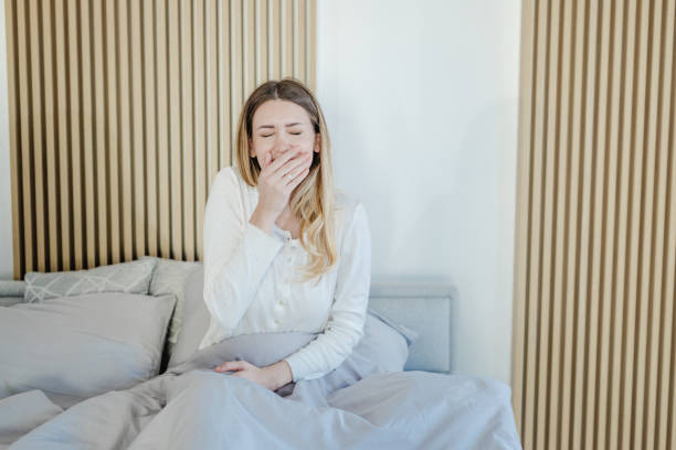 istock Young woman is in bed and yawns 1400613144