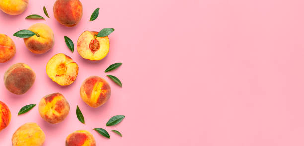 istock Summer fruit background. Flat lay composition with peaches. Ripe juicy peaches with green leaves on pink background. Flat lay top view copy space. Fresh organic fruit vegan food. Harvest concept 1400614702