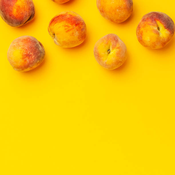 istock Summer fruit background. Flat lay composition with peaches. Ripe juicy peaches with green leaves on yellow background. Flat lay top view copy space. Fresh organic fruit, vegan food. Harvest concept 1400614704