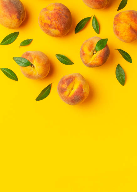 istock Summer fruit background. Flat lay composition with peaches. Ripe juicy peaches with green leaves on yellow background. Flat lay top view copy space. Fresh organic fruit, vegan food. Harvest concept 1400614712