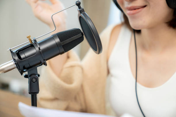 istock Female streaming audio podcast online at home 1400614796