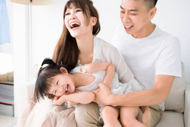 istock Happy Asian family having fun at home. 1400616298