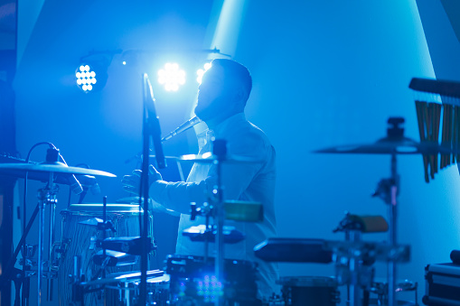 Drummer plays drums in jazz club