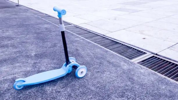 Photo of Blue scooter bike for kids parked in outdoor area