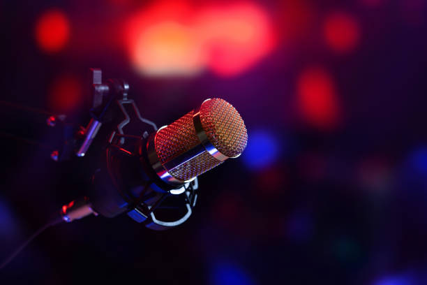 studio microphone in neon lights. sound recording equipment - microfone imagens e fotografias de stock