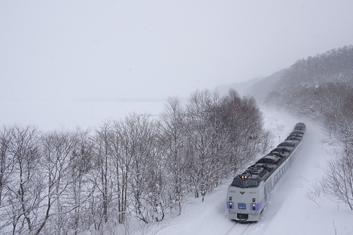 Nanae-cho, Hokkaido, Japan - February 20, 2018 : Frozen Onuma and KIHA 183 Limited express “Hokuto”