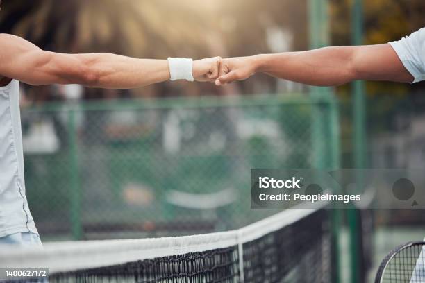 Two Unknown Ethnic Tennis Players Giving Fistbump With Fist Before Playing Court Game Fit Athletes Team Standing And Using Hand Gesture For Good Luck Play Competitive Sports Match For Health Fitness Stock Photo - Download Image Now