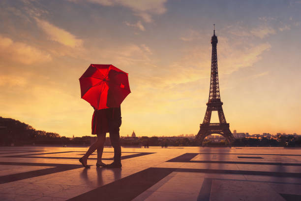 Paris, silhouette of couple kissing near Eiffel tower stock photo