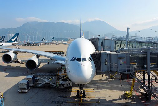 Hong Kong, China: Singapore Airlines Airbus A380-841 loading cargo - a double passenger boarding bridge (PBB) is required to fit the 2-deck configuration of the airliner - Terminal 1, Hong Kong International Airport - Chek Lap Kok island