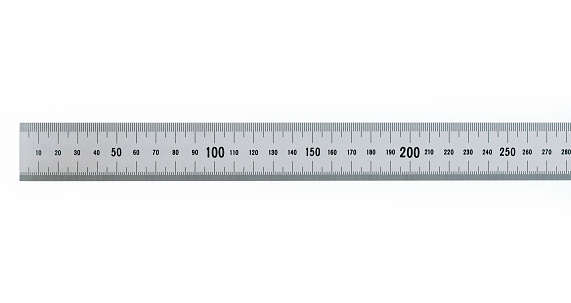 Close-up of white scale ruler on ruler next to architectural model