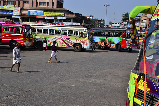 Thalassery, Kerala, India - January, 2017: Bus station with customized painted Indian buses. colorful Indian buses with abstract patterns and animal designs. Local bus station with motor coaches
