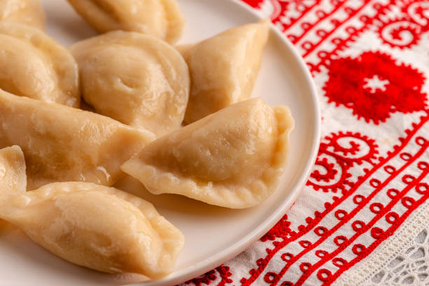 Dumplings, filled with mashed potatoes. Dumplings, filled with mashed potatoes. Russian, Ukrainian or Polish dish: varenyky, vareniki, pierogi, pyrohy. pierogi stock pictures, royalty-free photos & images