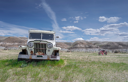 Dorothy, Alberta, Canada – May 21, 2022:  Old abandoned Jeep on the prairie grassland