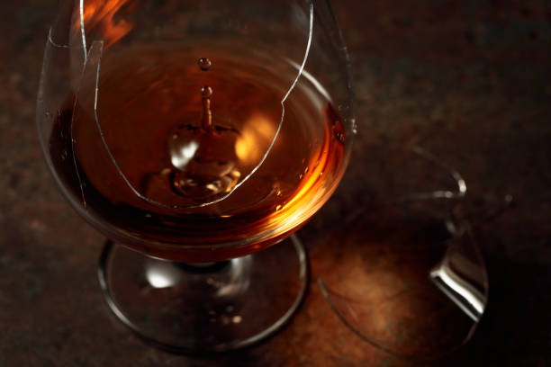 istock The drop of brandy falls into a broken glass. 1400634807