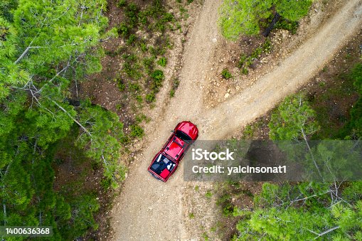 istock Top view photo of Red pick up lost in the forest road 1400636368