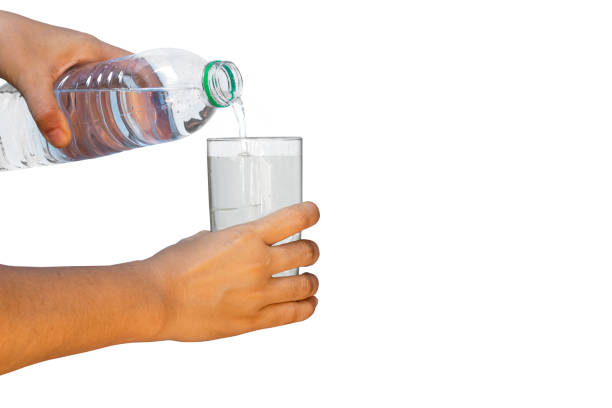 istock Hand pouring water from from bottle into glass 1400637950
