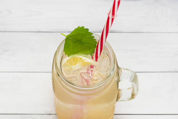 istock Cold lemonade with lemon slices and ice in a misted glass. View from above 1400639121